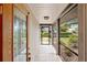 Inviting entryway with decorative glass door, tile flooring, and screened porch at 2778 Greendale Dr, Sarasota, FL 34232