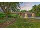 Charming single-story home with a well-manicured lawn, mature trees, and a two-car garage at 2778 Greendale Dr, Sarasota, FL 34232