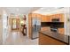 Open concept kitchen with stainless steel appliances and a breakfast bar at 2778 Greendale Dr, Sarasota, FL 34232