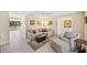 Spacious living area with neutral decor, tile flooring, and access to the pool area at 2778 Greendale Dr, Sarasota, FL 34232