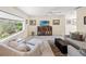 Comfortable living room featuring neutral tones, ample natural light, and tile flooring at 2778 Greendale Dr, Sarasota, FL 34232