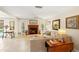 Inviting living room featuring a cozy fireplace, neutral tones and tile floors at 2778 Greendale Dr, Sarasota, FL 34232