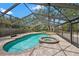 Enclosed in-ground pool and spa, with brick-paved surround, perfect for outdoor relaxation and entertainment at 2778 Greendale Dr, Sarasota, FL 34232