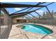 Enclosed in-ground pool and spa, with brick-paved surround, ideal for relaxation and leisure at 2778 Greendale Dr, Sarasota, FL 34232