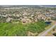 Aerial view shows property layout, landscaping, and nearby pond adding to the natural setting at 28706 102Nd E Dr, Myakka City, FL 34251