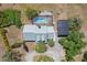 This aerial shows the house with a pool, screened enclosure, and solar panel array at 28706 102Nd E Dr, Myakka City, FL 34251