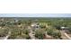 Expansive aerial view showcases the home's setting with mature trees and the surrounding landscape at 28706 102Nd E Dr, Myakka City, FL 34251