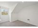 Attic room with carpet, dormer window and electric heater at 28706 102Nd E Dr, Myakka City, FL 34251