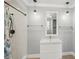 Bathroom featuring a walk-in shower, modern sink vanity and mirror, and updated fixtures at 28706 102Nd E Dr, Myakka City, FL 34251
