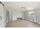 Bedroom with tile flooring, access to bathroom, walk-in closet, and large windows at 28706 102Nd E Dr, Myakka City, FL 34251