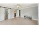 Bedroom with tile flooring, crown molding, barn door, and a walk-in closet at 28706 102Nd E Dr, Myakka City, FL 34251