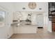 Spacious kitchen with white cabinetry, granite countertops, stainless steel appliances, and a large decorative clock at 28706 102Nd E Dr, Myakka City, FL 34251