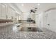 Modern kitchen featuring granite countertops, stainless steel appliances, and ample cabinet space at 28706 102Nd E Dr, Myakka City, FL 34251