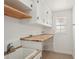Functional laundry room with built-in shelves and a wooden countertop, offering practical space at 28706 102Nd E Dr, Myakka City, FL 34251