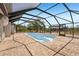 Outdoor pool featuring a screened in enclosure and brick patio at 28706 102Nd E Dr, Myakka City, FL 34251