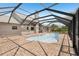 Exterior view of the home's screened-in pool with brick patio at 28706 102Nd E Dr, Myakka City, FL 34251