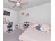 This cozy bedroom has carpeted floors, ample desk space, a ceiling fan, and a TV at 2969 Great Abaco Way, Bradenton, FL 34208
