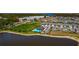 Aerial view of neighborhood community pool and surrounding lake at 2969 Great Abaco Way, Bradenton, FL 34208