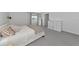 This spacious main bedroom has carpeted floors, ensuite bath access, and modern minimalist design with neutral tones and natural light at 2969 Great Abaco Way, Bradenton, FL 34208