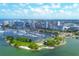 An aerial view showcasing a waterfront community, a marina filled with boats, and a vibrant cityscape at 3698 Glen Oaks Manor Dr, Sarasota, FL 34232