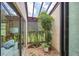 Serene atrium with lush greenery and a skylight at 3698 Glen Oaks Manor Dr, Sarasota, FL 34232