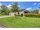 Beautiful home with lush green lawn, lovely landscaping, and an attached garage at 3698 Glen Oaks Manor Dr, Sarasota, FL 34232