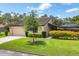 Well-maintained front yard with lush landscaping and charming curb appeal at 3698 Glen Oaks Manor Dr, Sarasota, FL 34232