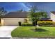 Charming one-story home with lush green lawn and mature landscaping enhancing its curb appeal at 3698 Glen Oaks Manor Dr, Sarasota, FL 34232
