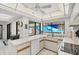 Light and airy kitchen with a window overlooking the pool area and modern appliances at 3698 Glen Oaks Manor Dr, Sarasota, FL 34232