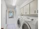 Well-equipped laundry room features a modern washer and dryer, and ample cabinet storage at 3698 Glen Oaks Manor Dr, Sarasota, FL 34232