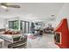Open-concept living area with tiled floors, lots of natural light and comfortable furniture at 3698 Glen Oaks Manor Dr, Sarasota, FL 34232