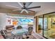 Relaxing outdoor patio area overlooking the private pool with comfortable seating and a ceiling fan at 3698 Glen Oaks Manor Dr, Sarasota, FL 34232