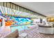 Private pool area with unique mural, comfortable seating, and a covered patio at 3698 Glen Oaks Manor Dr, Sarasota, FL 34232