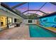 Inviting screened-in pool area featuring comfortable seating and a vibrant mural for outdoor enjoyment at 3698 Glen Oaks Manor Dr, Sarasota, FL 34232