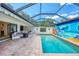 Secluded pool featuring a beach mural, covered seating, and lush landscaping at 3698 Glen Oaks Manor Dr, Sarasota, FL 34232