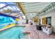 Inviting pool area with a unique mural, covered patio, and plenty of space for lounging at 3698 Glen Oaks Manor Dr, Sarasota, FL 34232
