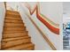 Wooden staircase with a unique painted design on the adjacent wall at 3698 Glen Oaks Manor Dr, Sarasota, FL 34232