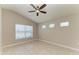 Bright bedroom with a ceiling fan, neutral paint, tile floors, and windows at 4031 Cottage Hill Ave, Parrish, FL 34219
