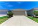 Attached two car garage with neutral door and long driveway at 4031 Cottage Hill Ave, Parrish, FL 34219