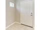 Hallway with light beige paint, a white interior door, and tan porcelain tile at 4031 Cottage Hill Ave, Parrish, FL 34219