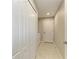 Hallway featuring the laundry closet, additional closet space, and access to other rooms at 4031 Cottage Hill Ave, Parrish, FL 34219