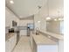 Bright kitchen features stainless appliances, pendant lights and breakfast bar at 4031 Cottage Hill Ave, Parrish, FL 34219