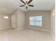 Inviting living room features tile floors, neutral paint, a modern ceiling fan, and ample natural light at 4031 Cottage Hill Ave, Parrish, FL 34219