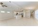 Open-concept living space with tile floors, a modern ceiling fan, white kitchen with stainless appliances, and a dining area at 4031 Cottage Hill Ave, Parrish, FL 34219