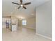 Spacious open-concept living area with tile floors, ceiling fan, a kitchen with island, and dining area with chandelier at 4031 Cottage Hill Ave, Parrish, FL 34219