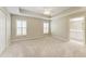 Spacious main bedroom features a tray ceiling, fan, and carpeted floors at 4031 Cottage Hill Ave, Parrish, FL 34219