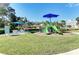 Community playground featuring slides, swings, and shaded seating area at 4031 Cottage Hill Ave, Parrish, FL 34219