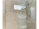 Tiled walk-in shower with glass door, shower head, and a toilet at 4031 Cottage Hill Ave, Parrish, FL 34219