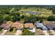 Aerial view of a cozy home with a screened-in pool near a golf course and ponds, offering serene outdoor living at 4219 Berkshire Dr, Sarasota, FL 34241