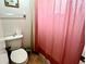 Bathroom featuring a toilet, shower with pink curtain, and tile floor at 4219 Berkshire Dr, Sarasota, FL 34241